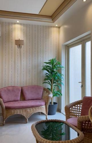 a living room with a couch and a table at Levant Hotel فندق قصر المشرق in Najran