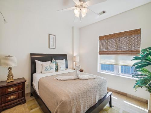 a bedroom with a bed and a window at Ocean Grove 704-ocean View in Galveston