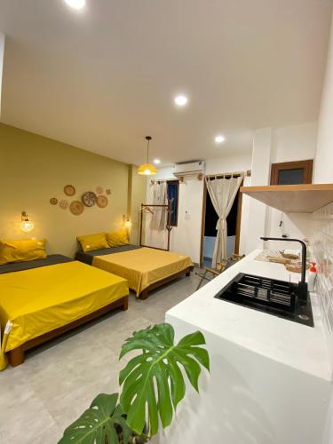 a living room with two beds and a kitchen at VYA homestay Huế in Thôn Lại Thê