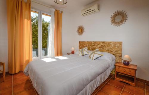 a bedroom with a large white bed and a window at Nice Home In Casalabriva With Wifi in Casalabriva