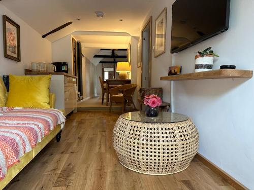 a living room with a bed and a table in a room at Thatchcombe B&B in Wantage