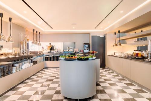 a kitchen with a counter with food on it at NYX Esperia Palace Hotel Athens by Leonardo Hotels in Athens