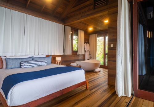 a bedroom with a bed and a bath tub in it at Secret Bay in Portsmouth