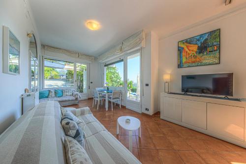 a living room with a couch and a flat screen tv at Villa Orchidea by PortofinoHomes in Santa Margherita Ligure