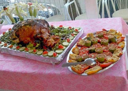 a table with two plates of food on a pink table at Hotel St. Moritz in Rimini