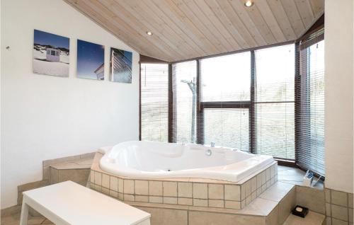 a large bath tub in a room with windows at Holiday Home Ruthsvej in Grønhøj