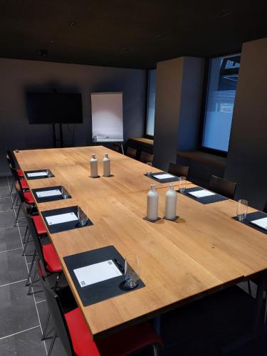 a large wooden conference table in a room with chairs at Hotel Artist in Biel