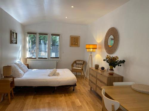 une chambre avec un lit, une table et des chaises dans l'établissement Cocon cosy aux portes de Paris / Joinville-le-Pont, à Joinville-le-Pont