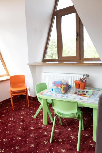 a dining room with a table and chairs at VitaPark Stariy Dub in Truskavets