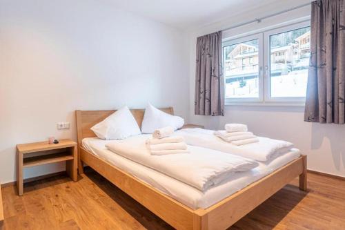 a bedroom with a bed with two pillows on it at Appartementhaus zum Moserlhof in Ennsling