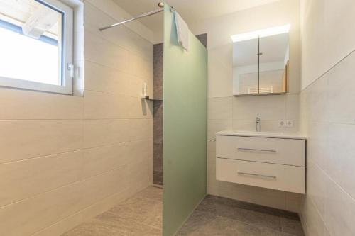 a bathroom with a sink and a mirror at Appartementhaus zum Moserlhof in Ennsling