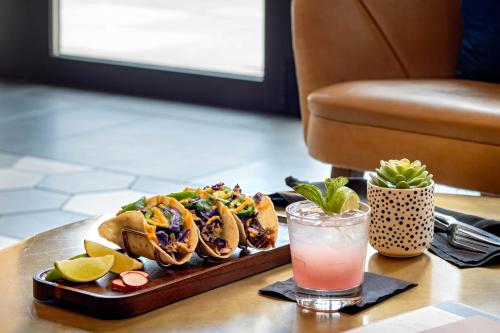 a tray of tacos and a drink on a table at Hyatt House Indianapolis Downtown in Indianapolis