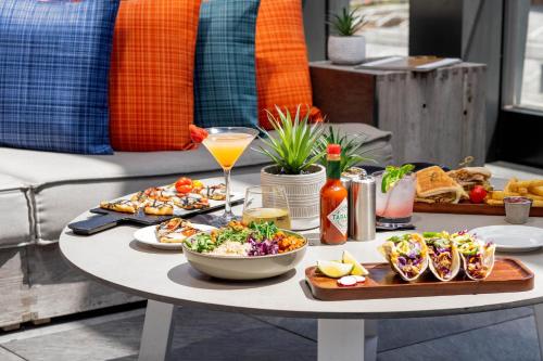 a table with food and drinks on a table at Hyatt House Indianapolis Downtown in Indianapolis