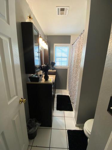 a small bathroom with a sink and a toilet at Xscapecation Oasis in Tulsa