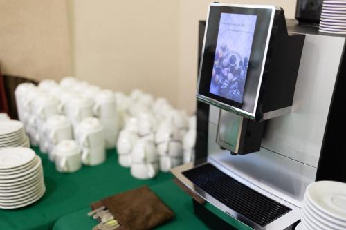 a machine with a pile of cups and plates on a table at VitaPark Stariy Dub in Truskavets