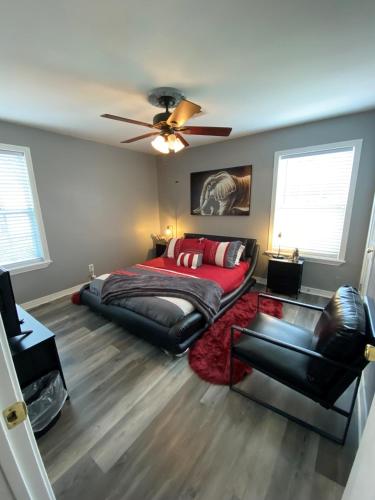 a bedroom with a bed and a ceiling fan at Xscapecation Oasis in Tulsa