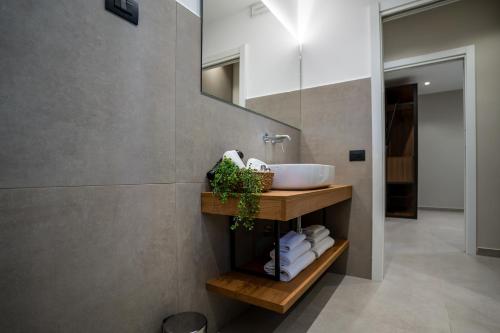 a bathroom with a sink and a mirror at Virdamuri - Etna Country Resort in Giarre