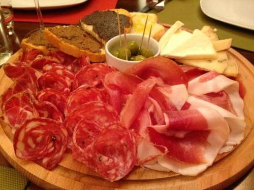 a plate of food with tomatoes and cheese and bread at Hotel St. Moritz in Rimini