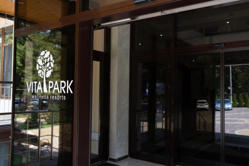 a pair of glass doors to a building with a sign on it at VitaPark Stariy Dub in Truskavets