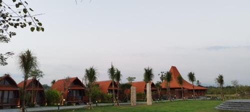 a row of houses with red roofs and palm trees at Love Without boundaries num9843 in Siyut