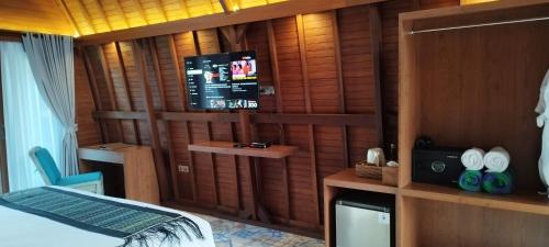 a bedroom with wooden walls and a bed and a tv at Love Without boundaries num9843 in Siyut