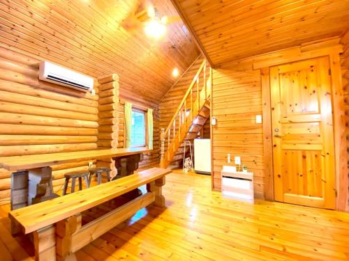 a wooden room with a bench in a log cabin at on a journey 千葉 九十九里 in Kujukuri