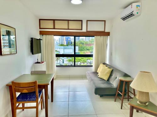 a living room with a couch and a table at Ondina Apart Hotel Residences in Salvador