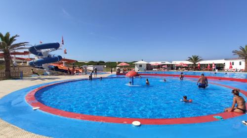 a large swimming pool with people in the water at Praia da Vagueira - Lights, Sea, Action! in Gafanha da Boa Hora