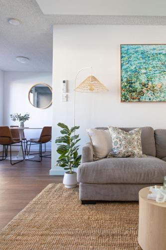 a living room with a couch and a table at By the Bay Batehaven - King, Queen, 2 x Singles in Batehaven
