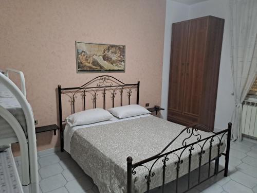 a bedroom with a bed and a wooden cabinet at B&B SAN MARCO in San Marco Evangelista