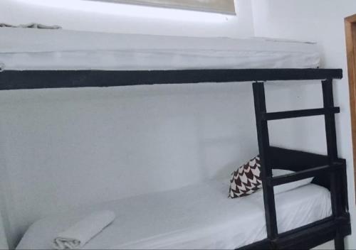 a bunk bed with a ladder in a room at Terramar Hoteles in Crucita