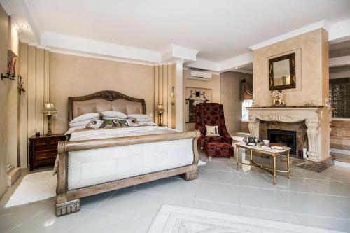 a bedroom with a bed and a fireplace at Villa Amor in Pretoria