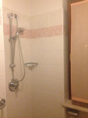 a bathroom with a shower with a shower curtain at Hotel Scandola in Bosco Chiesanuova