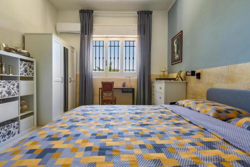 Un dormitorio con una cama tamaño king y un escritorio. en Casa di Margherita by BarbarHouse, en San Pietro in Bevagna
