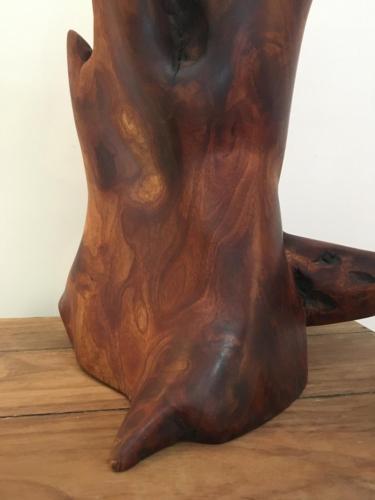 a wooden statue of a persons foot on a table at White Butterfly in Trivandrum