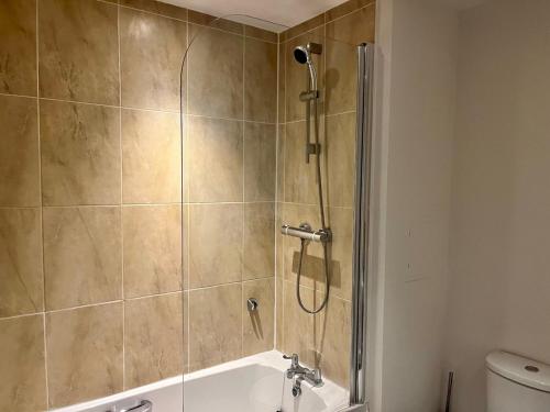 a bathroom with a shower with a tub at Pass the Keys Central Watford Apartment Sleeps 5 with Parking in Watford