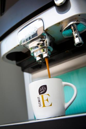 a cup of coffee is being poured into a coffee mug at Let's Meet Elewijt in Elewijt