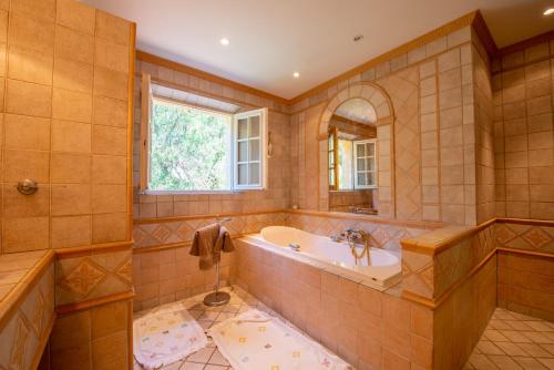 a large bathroom with a tub and a window at Paradis Provençal in Sainte-Maxime