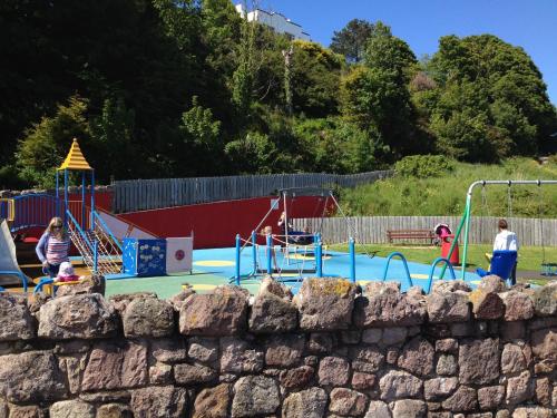 a group of people playing in a playground at Ballymacdoe Cottage Cushendall in Cushendall