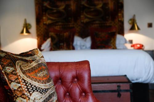 a bedroom with a bed and a couch with a pillow at Padstow Townhouse in Padstow