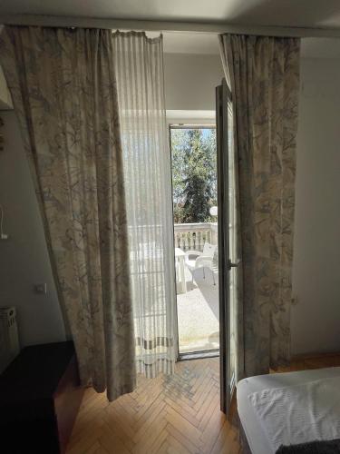 a bedroom with a sliding glass door to a patio at Vila Grinka M in Zaječar