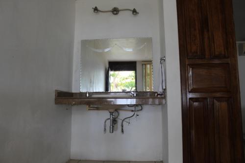 a bathroom with a sink and a mirror at Freedom Shores "La Gringa" Hotel - Universally Designed in Isla Aguada