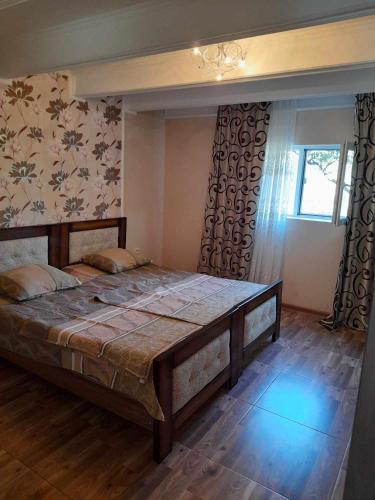 a bedroom with a large bed in a room at Zhanas home anaklia in Anaklia