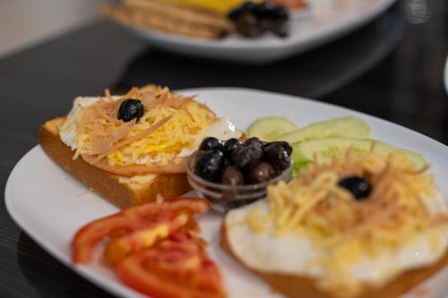a plate of food with sandwiches and vegetables on a table at Appart Hotel Star in Tangier