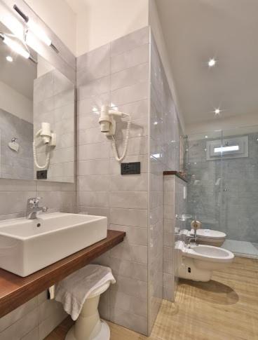 a bathroom with a sink and a toilet at Hotel San Donato - Bologna centro in Bologna