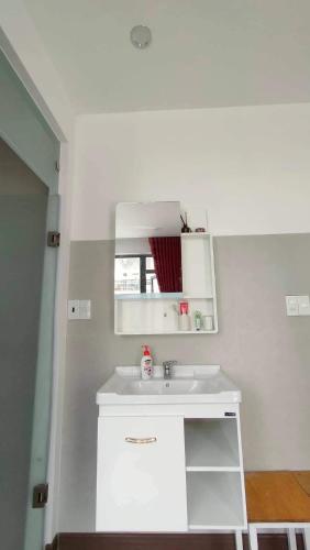 a bathroom with a white sink in a room at Hoshi DaLat House in Da Lat