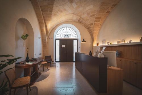 a hallway with a table and a door in a building at Palazzo Fontana B&B e SPA in Gravina in Puglia