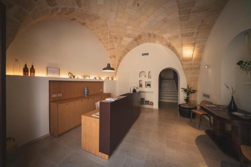 a tasting room in a building with a stone wall at Palazzo Fontana B&B e SPA in Gravina in Puglia