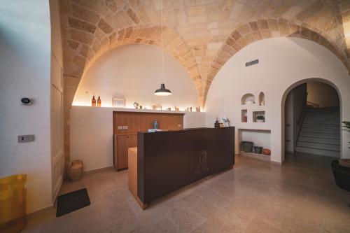 a living room with arched ceilings and a staircase at Palazzo Fontana B&B e SPA in Gravina in Puglia