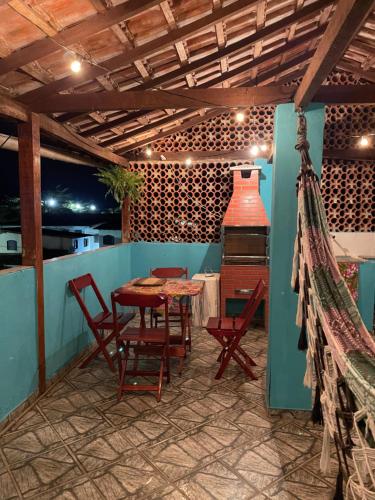 a patio with a table and chairs and a stove at Nova Conquista in Paraty